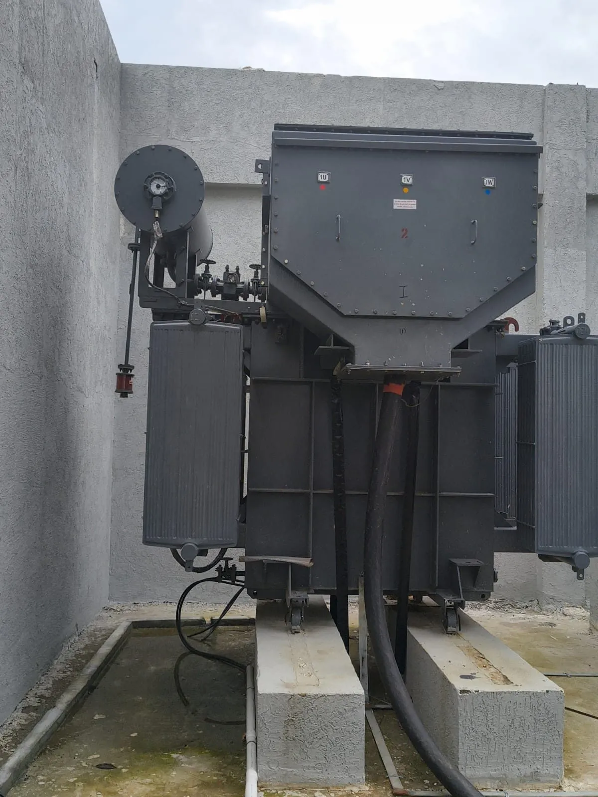 HV bushings and cable terminations on the side of an installed transformer