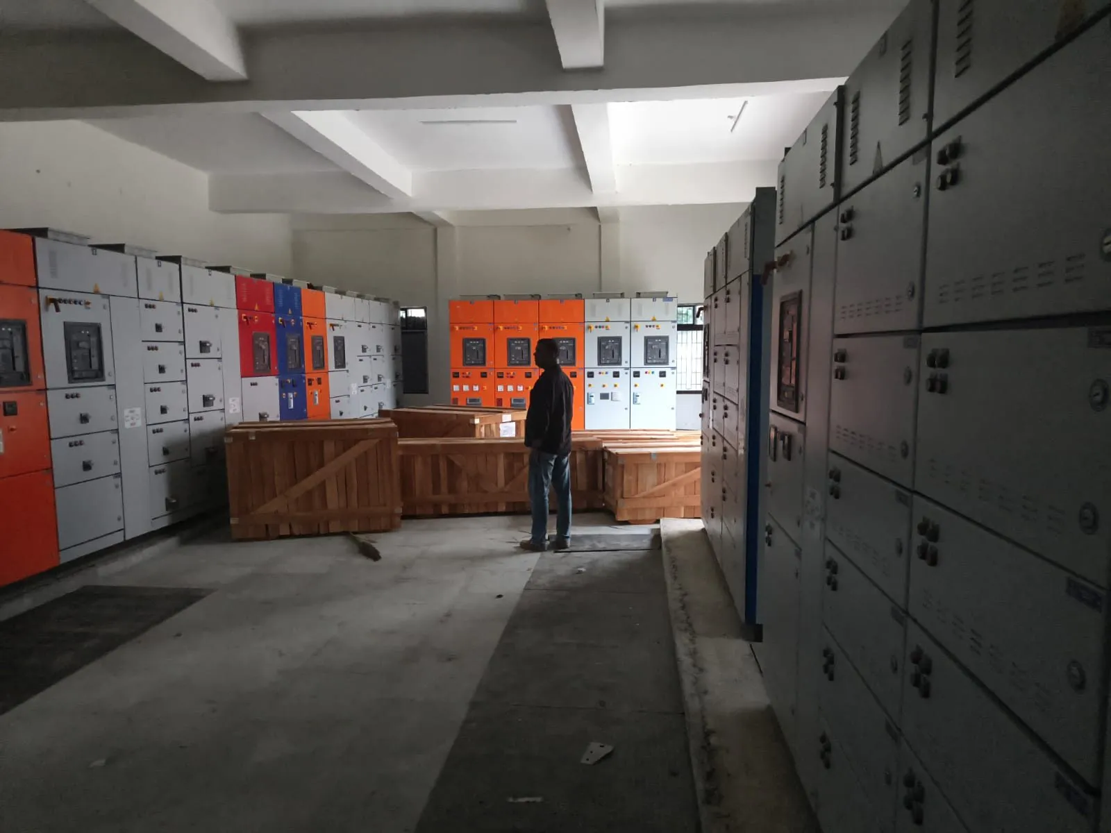 Rows of switchgear cubicles installed on both sides of a panel room
