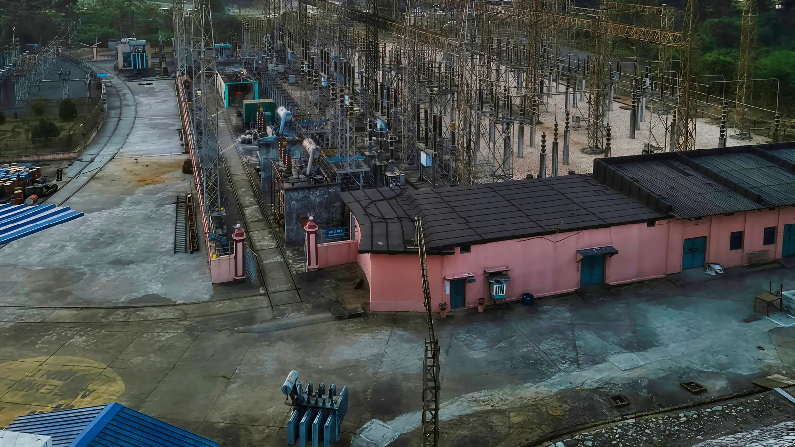 High-voltage 220/132/33 kV grid substation outdoor switchyard with power transformer banks and transmission towers