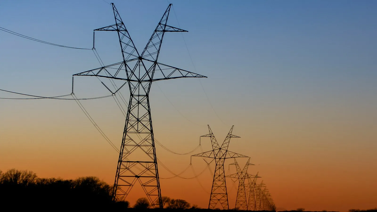 High-voltage 33 kV express transmission towers and conductor spans across plateau landscape