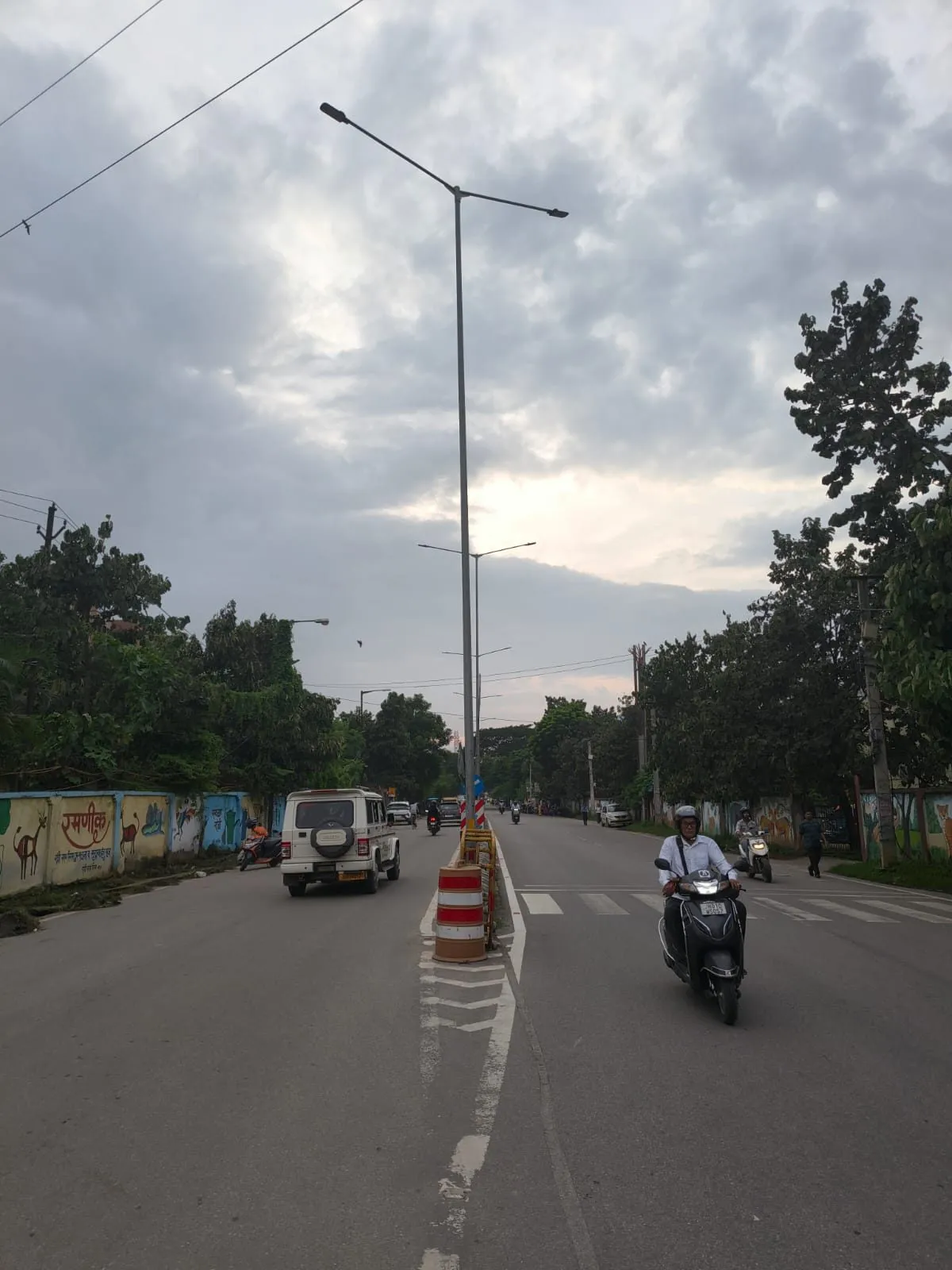 Octagonal steel street lighting poles installed along roadway